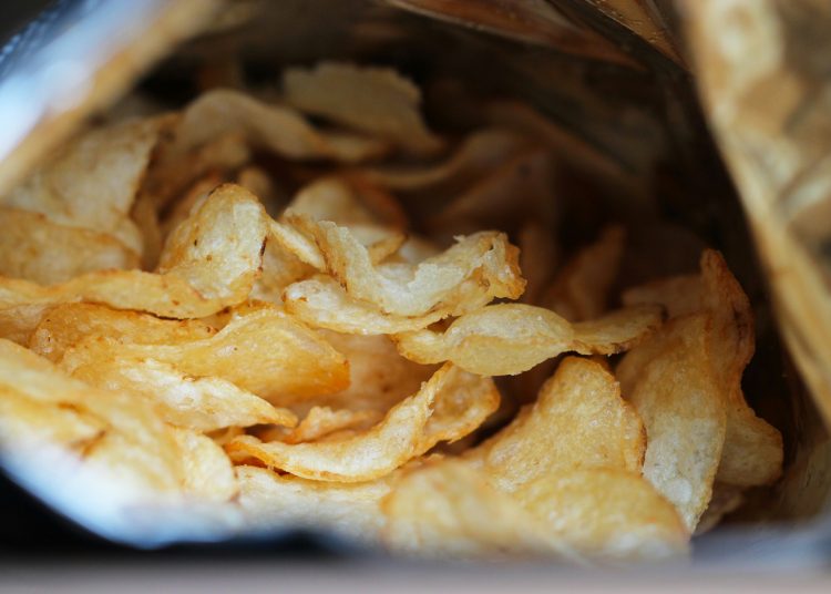 Close-up of crispy potato chips inside an open bag, useful storage tip for keeping chips and tortilla chips fresh longer