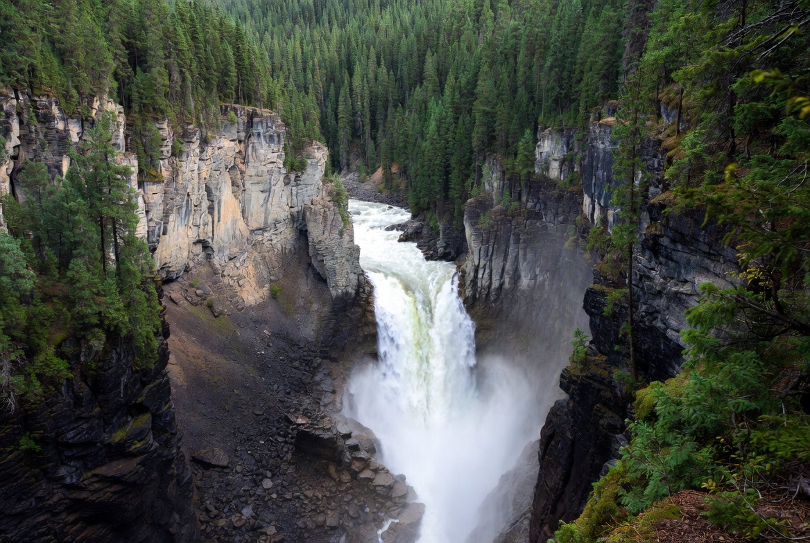 Helmcken Falls cascading into deep canyon at Wells Gray Provincial Park British Columbia Canada, powerful waterfall in lush forest