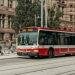 Red Toronto TTC streetcar on Queen Street with historic buildings and pedestrians in downtown Toronto, perfect example of affordable domestic travel Canada