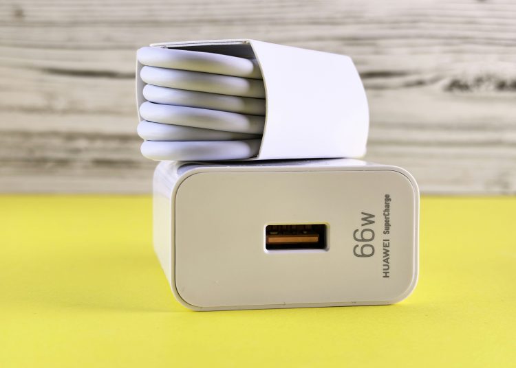 White Huawei 66W SuperCharge adapter with neatly coiled cable, life hack tip to label unique chargers and power cables so you always know what they belong to
