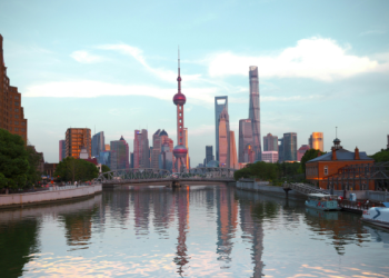 Shanghai Pudong skyline at dusk reflected in the Huangpu River, featuring the iconic Oriental Pearl Tower