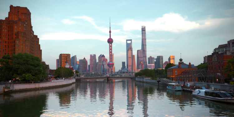 Shanghai Pudong skyline at dusk reflected in the Huangpu River, featuring the iconic Oriental Pearl Tower