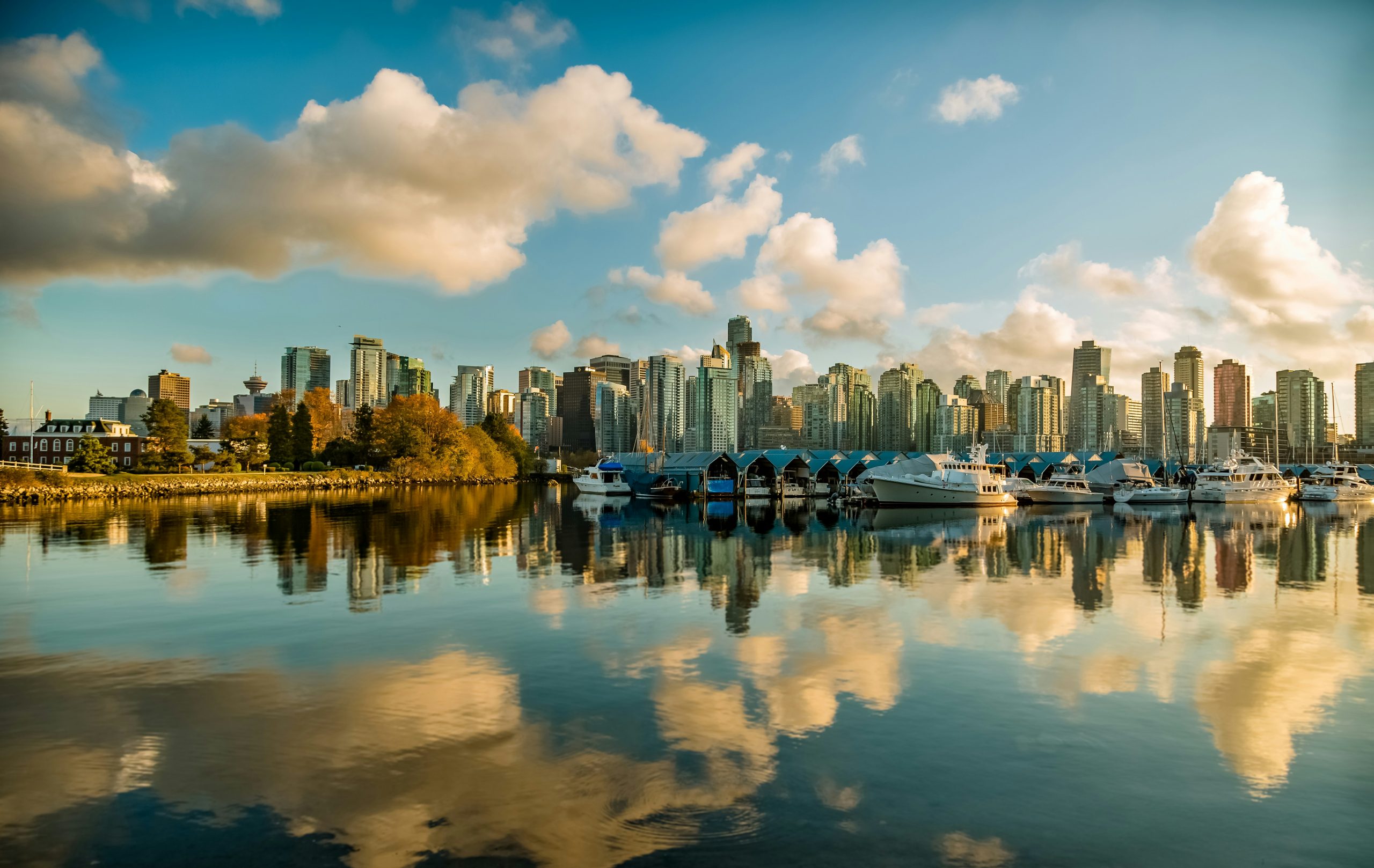 Vancouver skyline at sunset with boats in the harbor and perfect water reflections