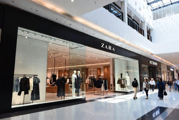 Zara fashion store exterior inside modern Canadian shopping mall with shoppers walking by