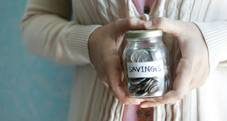 Grandma holding a jar of coins labelled savings